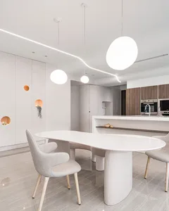 Modern kitchen with white furniture and minimalist design.