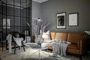 A modern industrial residential interior with steel and leather elements.