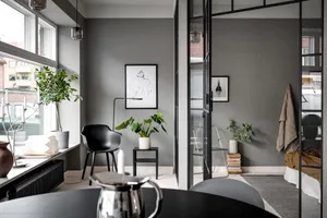 A minimalist interior with elements made of concrete, metal, and glass.