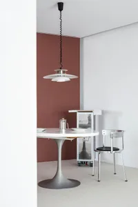 A minimalist kitchen featuring metal, glass, and wood elements.