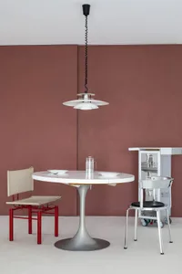 Modern dining room featuring metallic furniture and minimalist design.