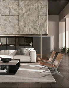 Modern living room featuring concrete, marble, and leather materials and furniture.