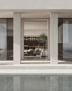 A modern living room with glass walls and marble flooring, featuring minimalist furniture and a potted plant.