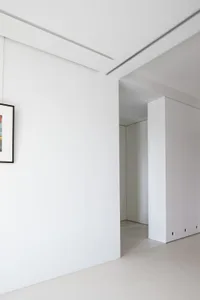 Minimalist bedroom with white walls and furniture