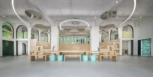 A modern play room with wooden structures and seating.