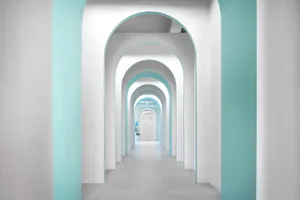 Modern architectural interior designed with white and blue accents, showcasing contemporary design elements.