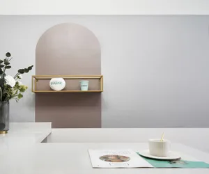 A modern kitchen counter setup with metal shelving.