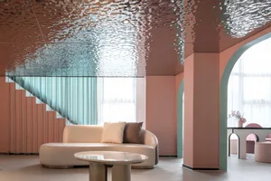 A modern living room with a metallic ceiling and curved seating area.