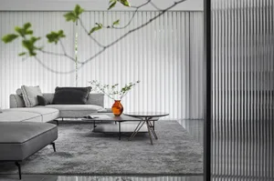 Modern minimalist living room with grey sofa, black coffee table, and white blinds.