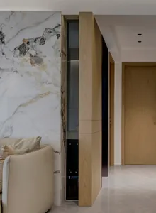 Modern minimalist living room with marble and wood accents, featuring a clean and sleek design.