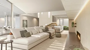 A modern living room with neutral tones in a contemporary design style, featuring a spacious couch, minimalistic decor, and a