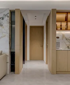 Modern residential interior with wooden and marble finishes on the upper floor.