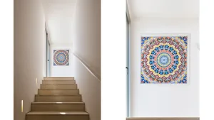 A modern staircase with a colorful, intricate painting on the wall.