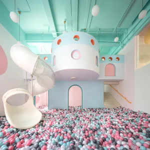 A playroom with a ball pit and a slide