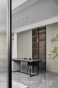Industrial home office with modern black accents, featuring a sleek desk, leather chair, and minimalist design.