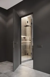 Modern, minimalist bathroom with glass shower stall, illuminated shelf, and sleek design.