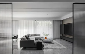 Modern minimalist living room featuring grey concrete furniture, large glass window, and sleek design.