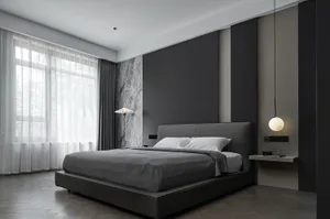 A modern bedroom featuring a black upholstered bed, white curtains, and minimalist decor.