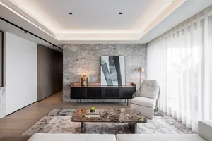 A modern living room with marble accents, featuring minimalist decor and a sleek, contemporary design.