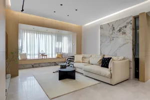 Modern living room featuring marble furniture and a comfortable sofa.