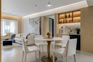 Modern residential space featuring marble and concrete finishes with minimalist furniture and lighting.