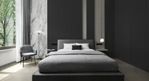 A minimalist bedroom with a fabric bed and marble accent wall