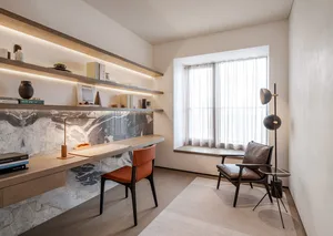 A modern office with a wooden desk, leather chair, and floating shelves.