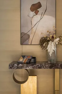 Modern entryway with marble table, dried floral arrangement, and abstract wall art