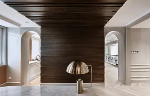 A modern interior space featuring dark wooden panels on the wall and ceiling.