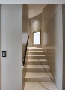 Modern, minimalist staircase with marble steps and walls