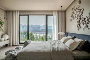 A minimalist bedroom with neutral colored furniture and decor.