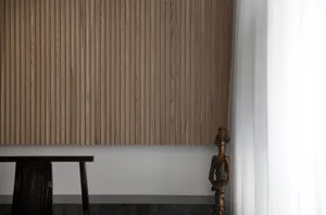 A minimalist bedroom featuring wooden paneling.