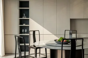Modern dining room with marble table and wooden chairs.
