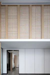 A modern entryway featuring a wooden lattice wall.