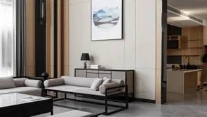 Modern minimalist living room with sleek black and white furniture and artwork.