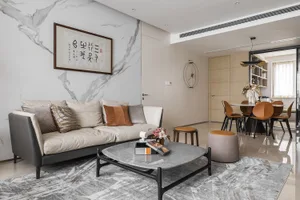 Modern living room featuring a marble sofa, leather accents, and wooden elements