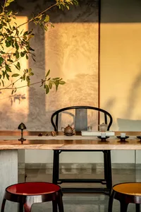 A traditional tea room featuring a wooden table with teapot and cups.