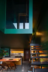 Contemporary kitchen with metal staircase and wooden accents