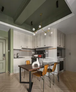 Modern kitchen with white cabinets, wooden table, and concrete flooring.