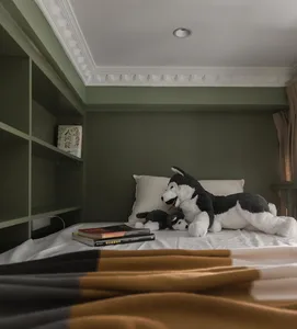 Bedroom with modern design elements, including soft furnishings and books.