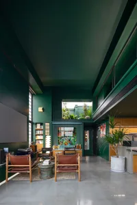 A modern living room with concrete walls and minimalist furniture.