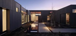 Modern residential house with a courtyard, featuring wooden textures and contemporary design.