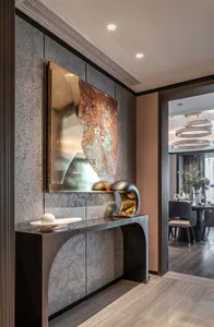 Modern entryway with metallic textured panels and contemporary art piece.