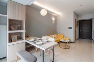 Modern living room with wooden furniture, fabric seating, ceramic floor, and metal accents.