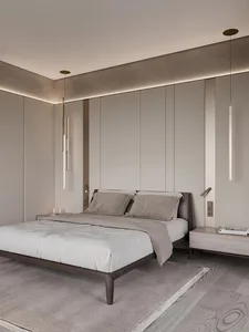 Modern, minimalist bedroom featuring a concrete wall and a cozy bed setup.