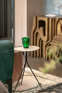 Modern living room featuring a green glass vase on a side table.