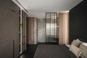 A modern bedroom featuring dark timber, concrete, and metal elements.