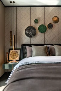 Bedroom featuring a modern bed with metallic headboard and green marble wall art, decorated with mixed fabrics and metallic l