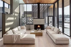 A modern living room featuring concrete walls, wooden furniture, and a wooden ceiling.