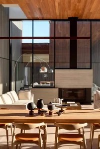 Modern living room with wooden furniture and floor-to-ceiling windows